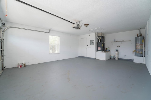 garage with concrete block wall, electric panel, a garage door opener, heating unit, and gas water heater