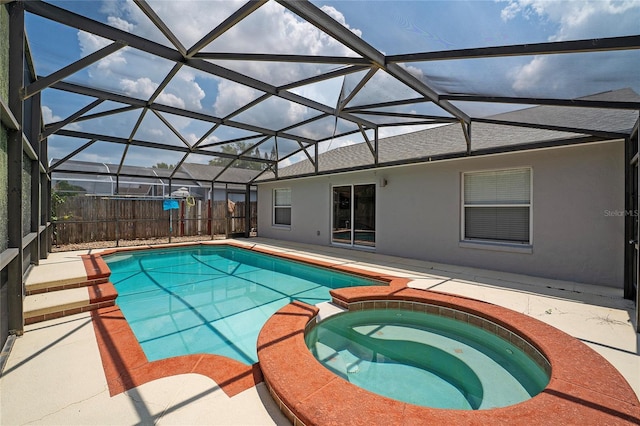 view of pool featuring a lanai, a pool with connected hot tub, a patio, and fence