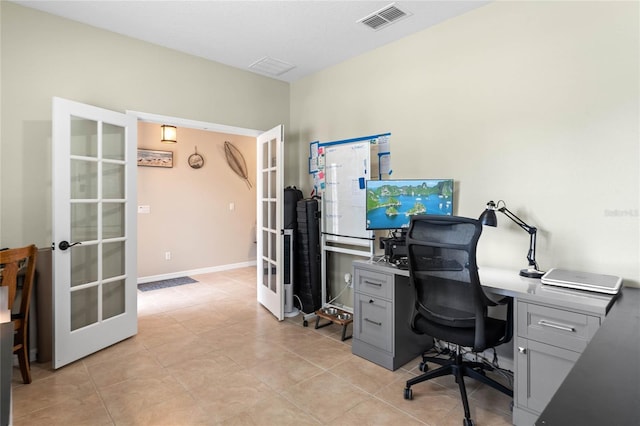 office with light tile patterned flooring and french doors