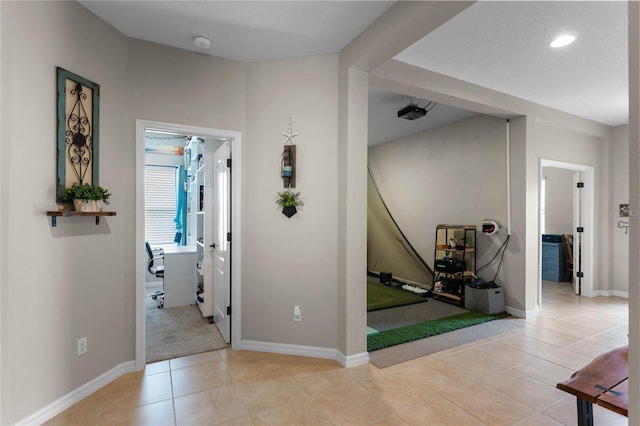 hall featuring light tile patterned flooring