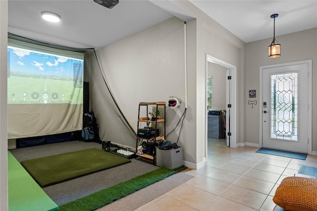 tiled entrance foyer featuring golf simulator