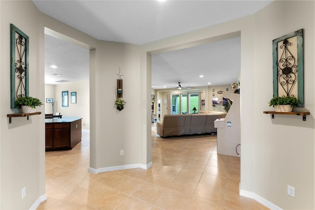 corridor featuring light tile patterned floors