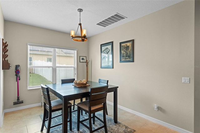 tiled dining area featuring a notable chandelier