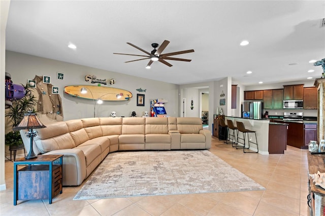 tiled living room with ceiling fan