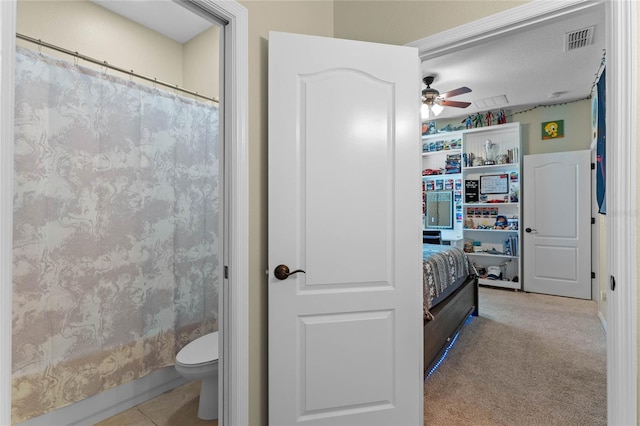 bathroom with tile patterned floors, toilet, and ceiling fan