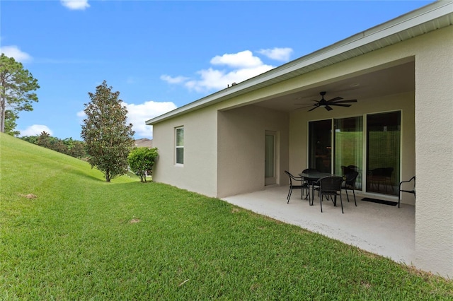 view of yard featuring ceiling fan and a patio area