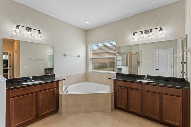 bathroom featuring plus walk in shower, vanity, and tile patterned floors