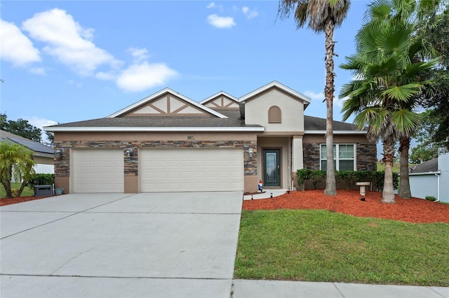 view of front of home with a garage and a front lawn