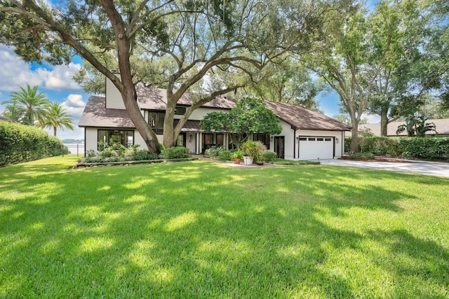 view of front of house featuring a garage and a front lawn