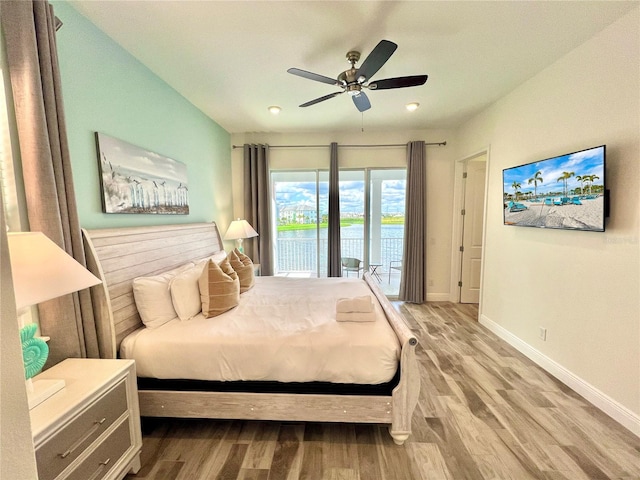 bedroom featuring access to outside, hardwood / wood-style floors, and ceiling fan