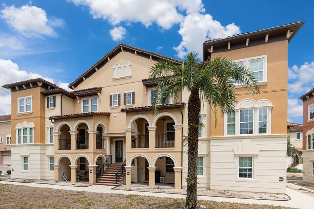 view of front facade featuring a balcony and a patio