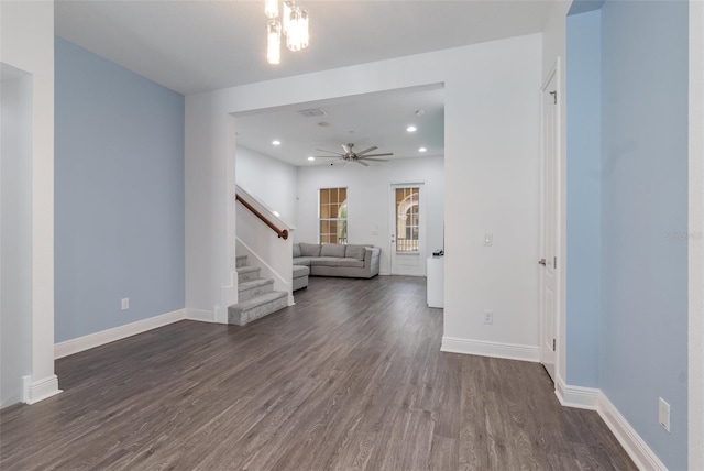 spare room featuring recessed lighting, visible vents, baseboards, dark wood-style flooring, and stairs