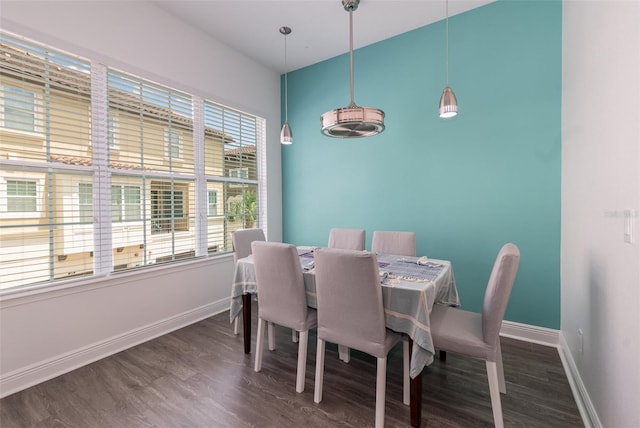 dining room with baseboards and dark wood-type flooring