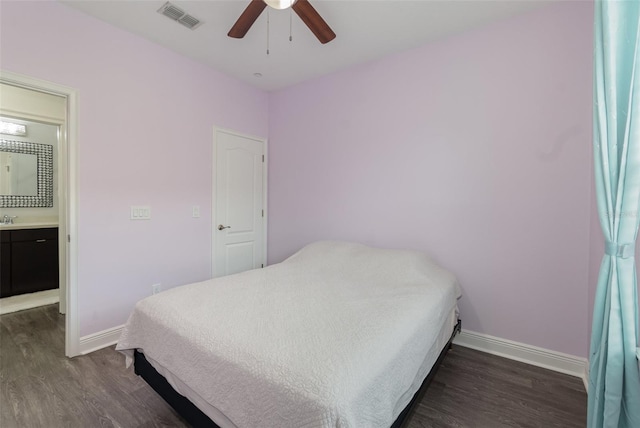 bedroom with baseboards, visible vents, and dark wood-style floors