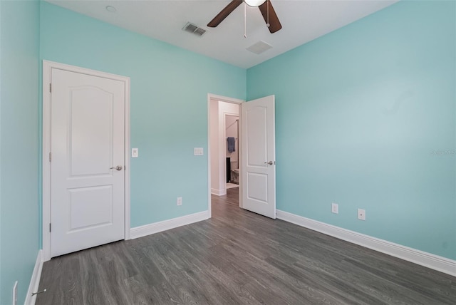 unfurnished bedroom featuring baseboards, visible vents, a ceiling fan, and dark wood-style floors