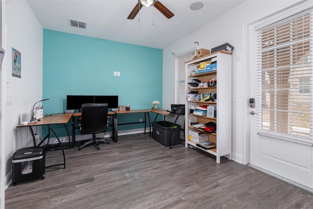 office area featuring dark wood-style flooring, visible vents, ceiling fan, and baseboards