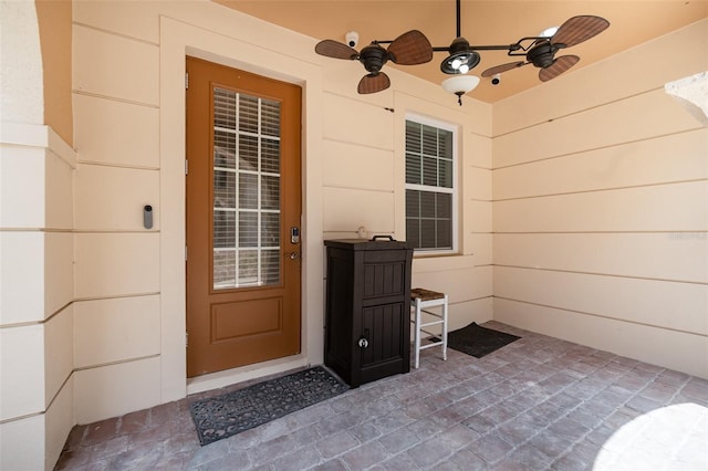 property entrance with ceiling fan