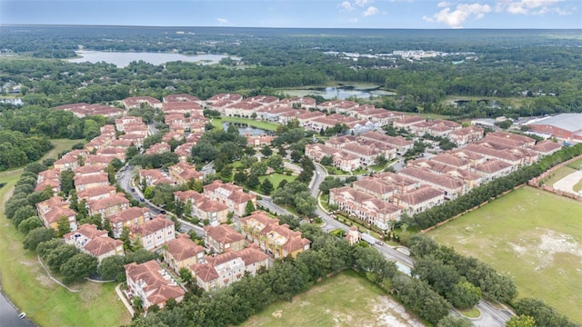 drone / aerial view with a water view and a residential view