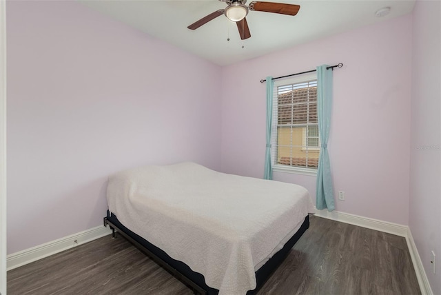 bedroom with ceiling fan, dark wood finished floors, and baseboards