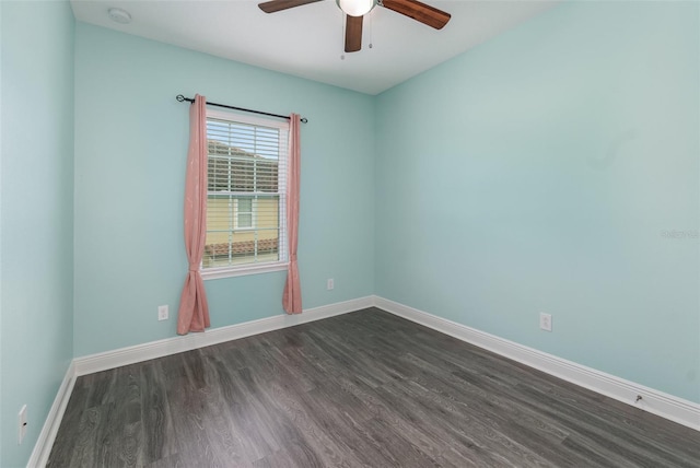 unfurnished room with dark wood-type flooring, baseboards, and a ceiling fan