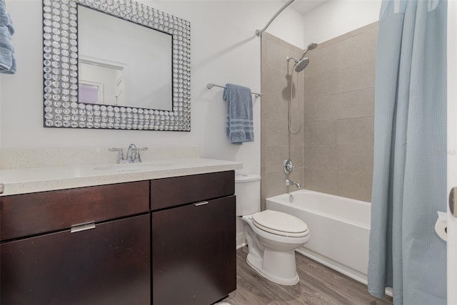 bathroom featuring toilet, vanity, wood finished floors, and shower / tub combo with curtain