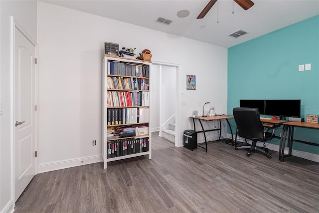 office space featuring ceiling fan, wood finished floors, visible vents, and baseboards