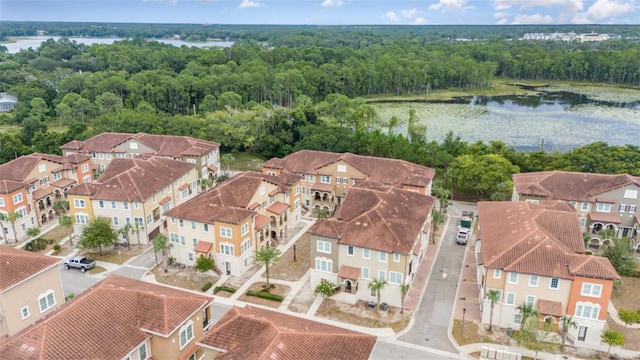 drone / aerial view featuring a residential view and a water view