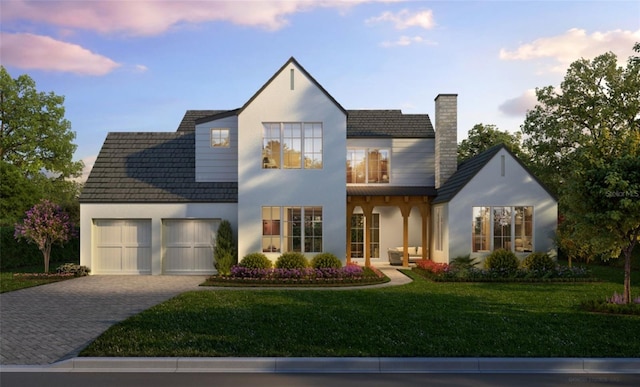 view of front of house featuring a garage and a yard