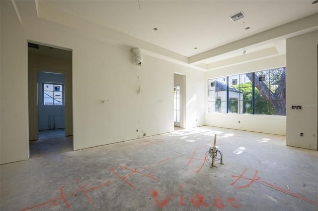 empty room featuring a raised ceiling