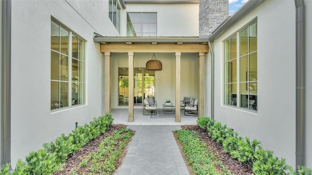 property entrance with stucco siding