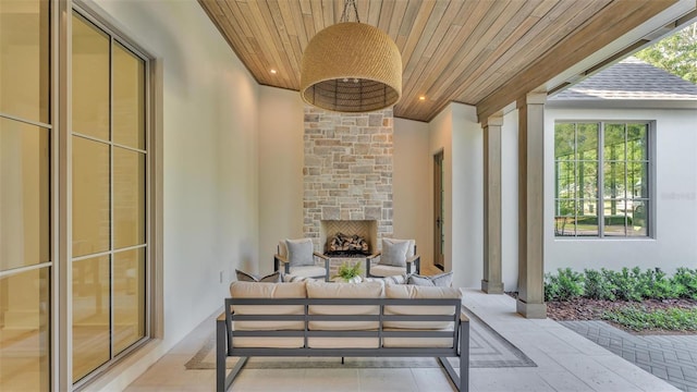 view of patio featuring an outdoor living space with a fireplace