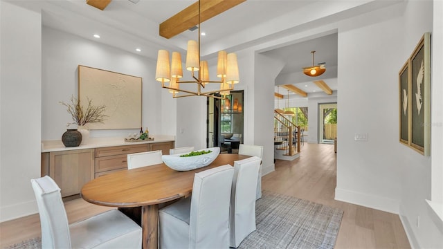 dining area with an inviting chandelier, light wood-style floors, beamed ceiling, and baseboards