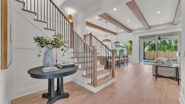stairs with baseboards, recessed lighting, wood finished floors, beam ceiling, and visible vents