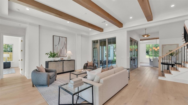 living room featuring stairway, beamed ceiling, light wood-style floors, and recessed lighting