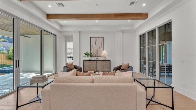 living area featuring visible vents, beamed ceiling, light wood-style flooring, and recessed lighting