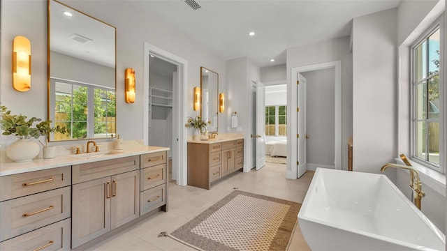 full bathroom featuring a wealth of natural light, visible vents, and a sink