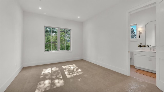 unfurnished bedroom with baseboards, recessed lighting, and light carpet