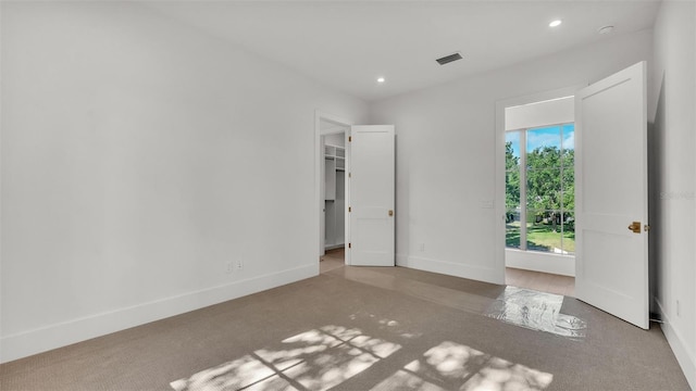 unfurnished bedroom with visible vents, recessed lighting, baseboards, and carpet floors