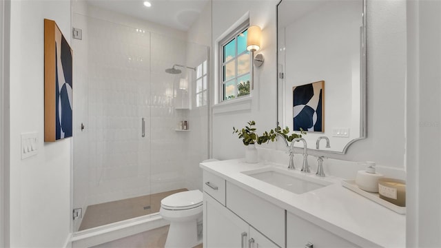 bathroom with recessed lighting, a stall shower, toilet, and vanity