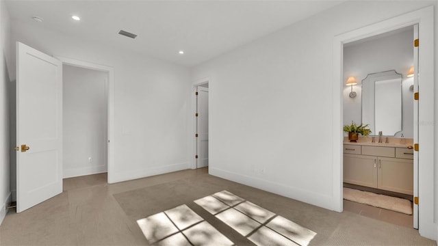 unfurnished bedroom featuring recessed lighting, a sink, connected bathroom, visible vents, and light colored carpet