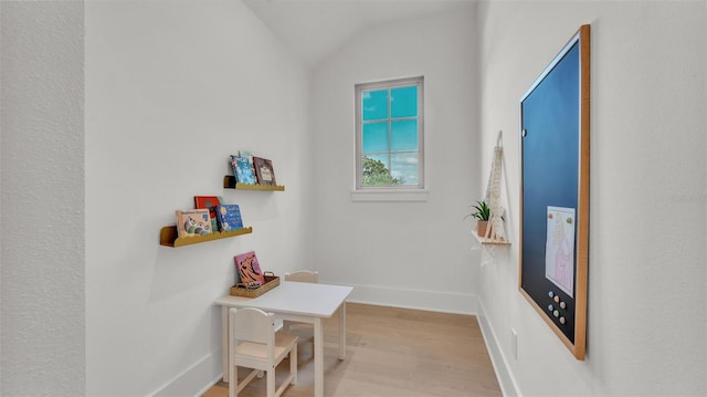doorway to outside with vaulted ceiling, wood finished floors, and baseboards