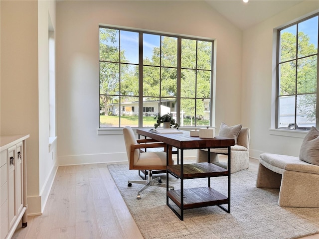 office with baseboards, lofted ceiling, and light wood-style flooring