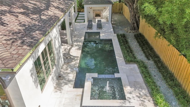 exterior space featuring a fenced in pool, a fenced backyard, and a patio area