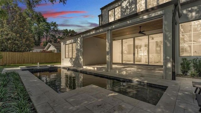 exterior space featuring fence, a patio area, and stucco siding