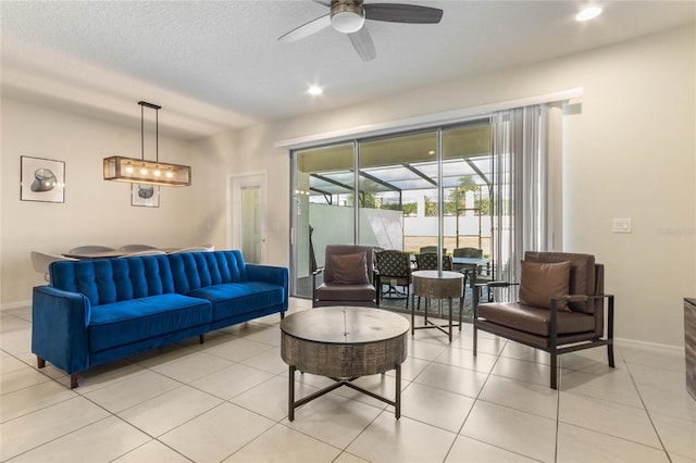 tiled living room featuring ceiling fan and a textured ceiling