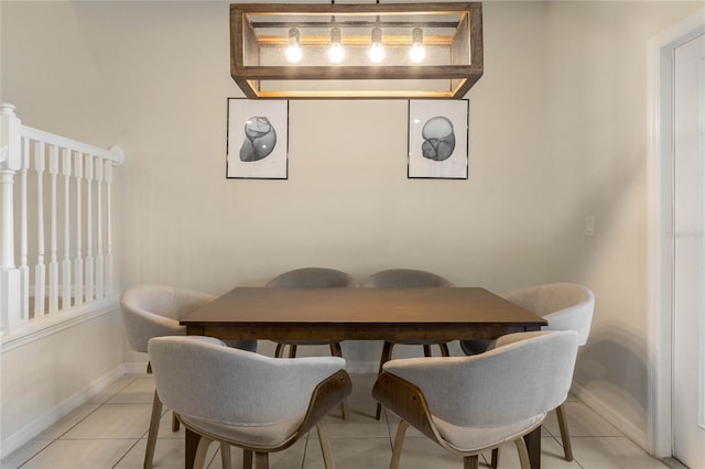 dining area featuring light tile patterned floors and baseboards