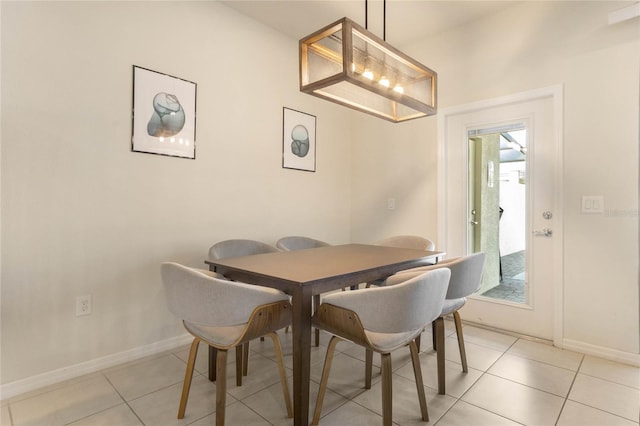 dining area with light tile patterned floors and baseboards