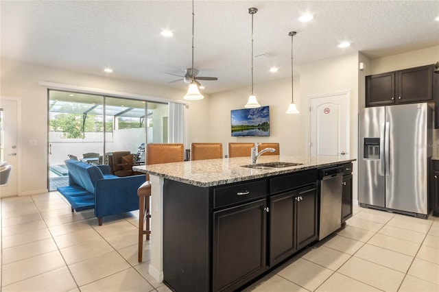 kitchen with sink, ceiling fan, an island with sink, and stainless steel appliances