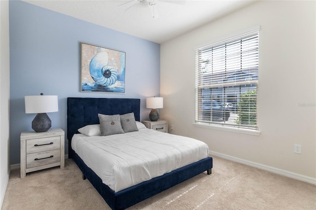 bedroom with ceiling fan and light colored carpet