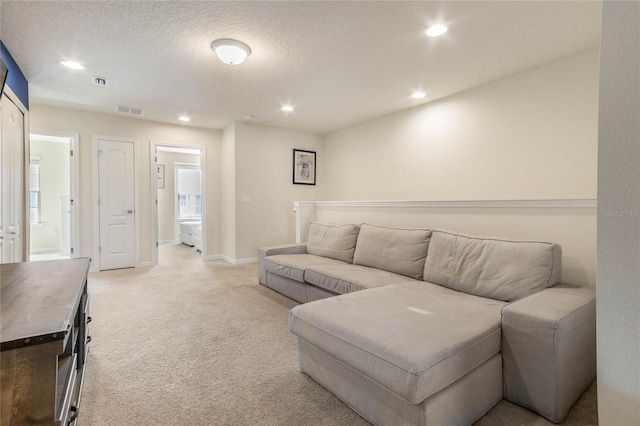 carpeted living room with a textured ceiling